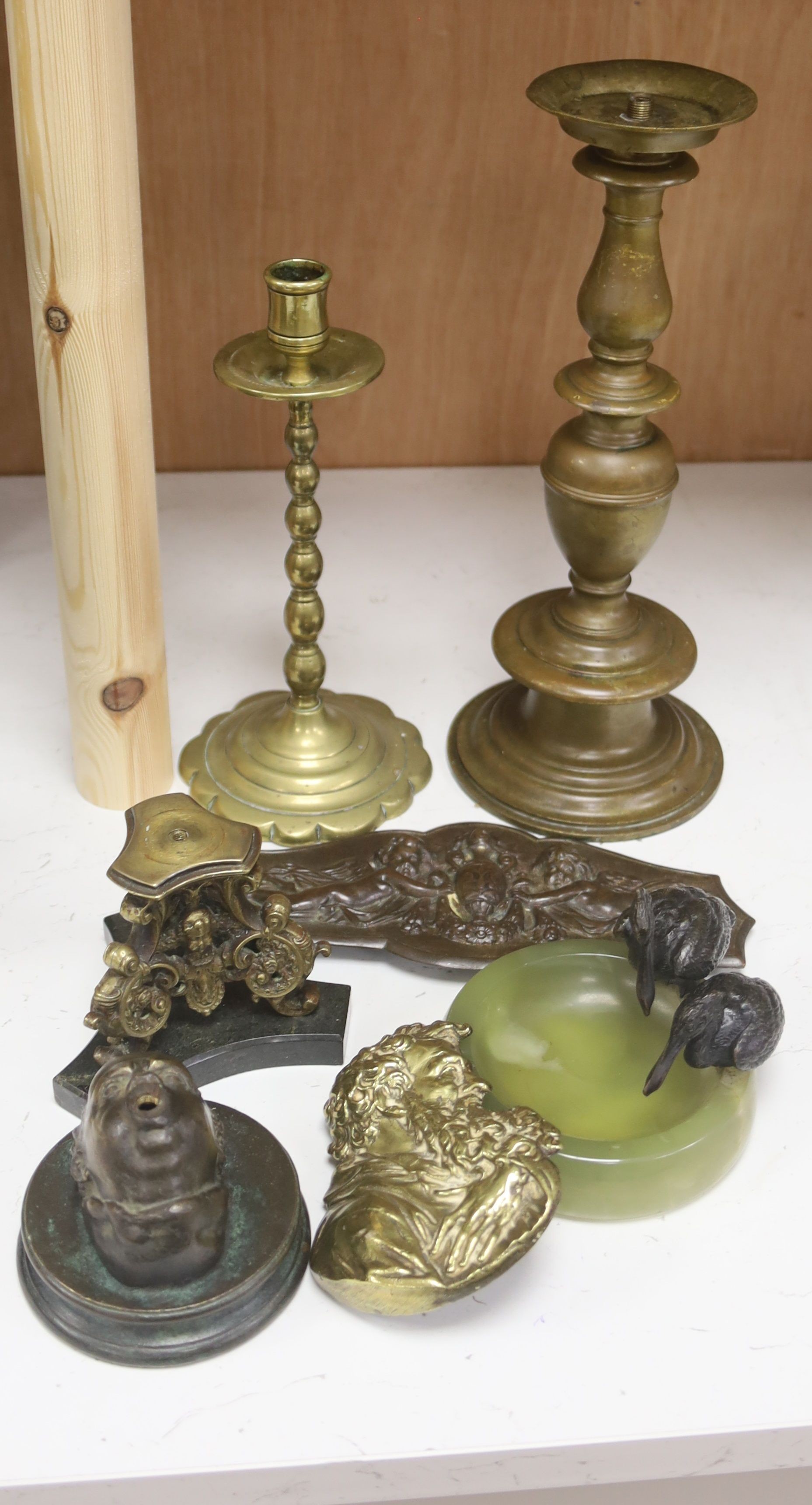 An Art Deco bronze 'pelican' and green onyx pin tray and various bronze and brass plaques, candlesticks etc., tallest 30cm